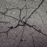 asphalt with cracks radiating across the surface