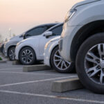 Car in parking lot parked in front of car stop